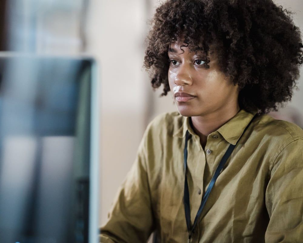 A finance professional focused on her analysis at her workstation