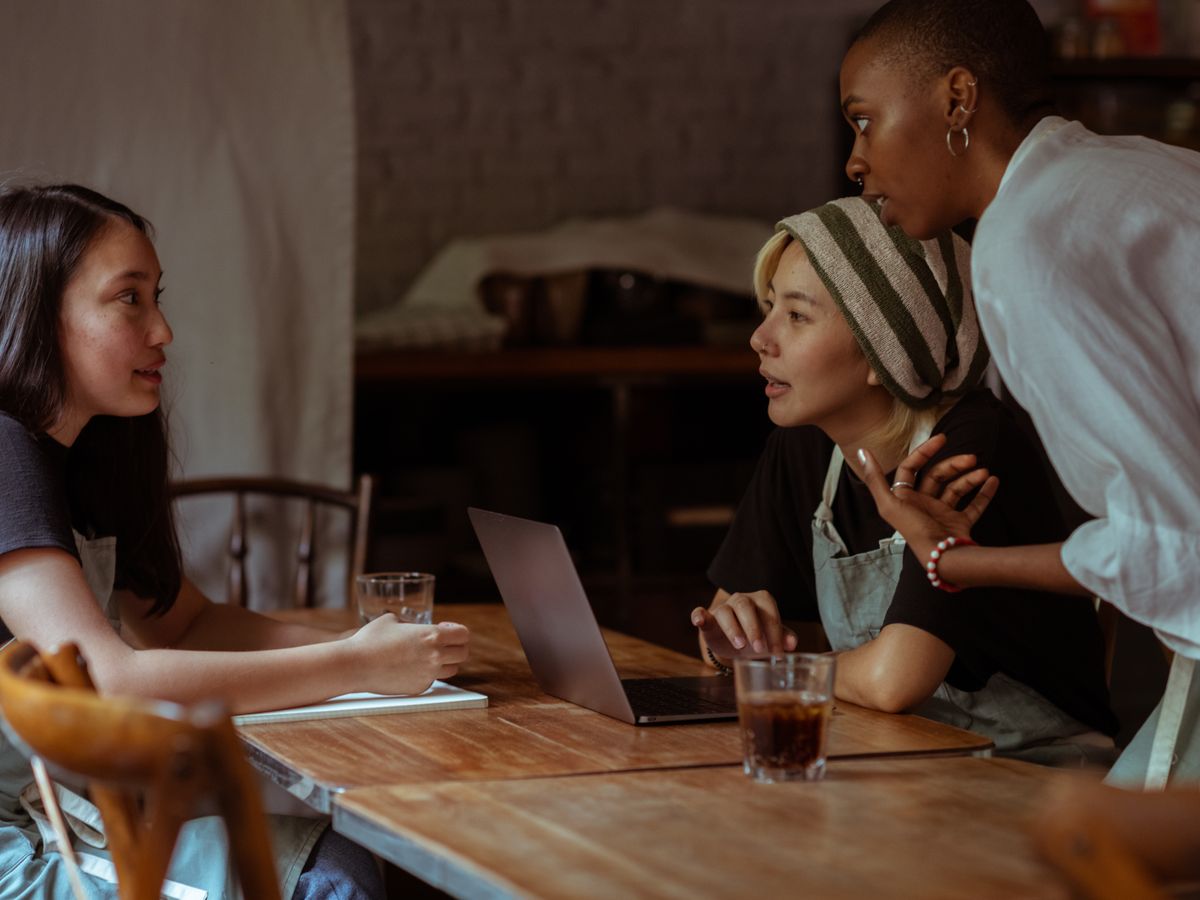 Marketers reviewing work together over a laptop