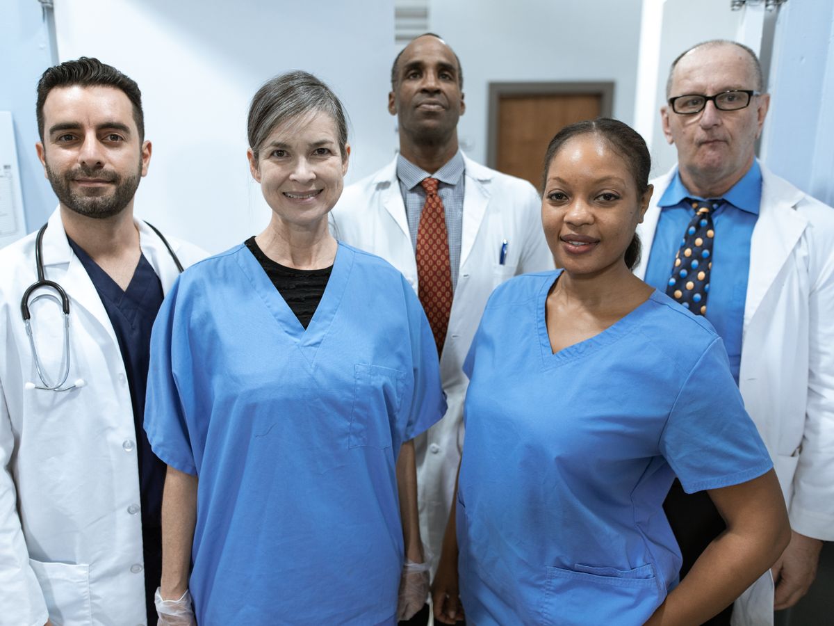 A diverse clinical care team standing together